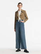 a lady in a camel lapel crop trench coat with a loose fit jeans